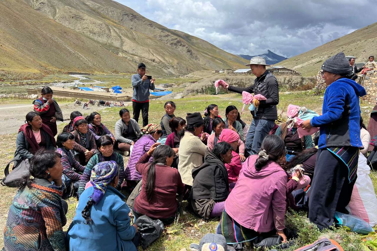 A nurse and doctor hand out hygiene kits to locals in a remote area of the Himalayas.