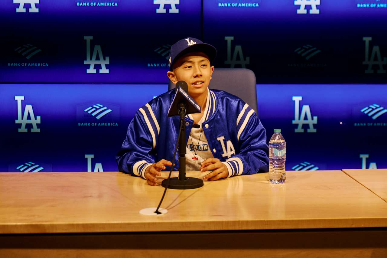 A teen oncology patient is the star of a mock press conference at Dodger Stadium.