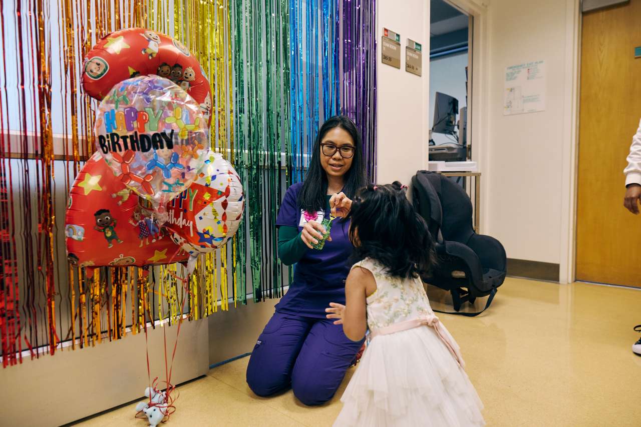 A Child Life Specialist celebrates a young girl's birthday.