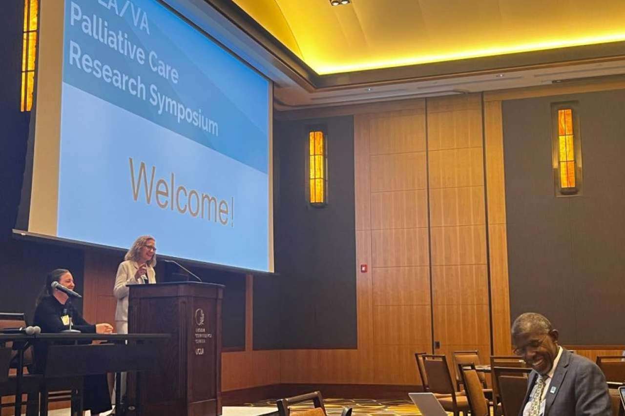 Woman giving presentation standing in front of dais