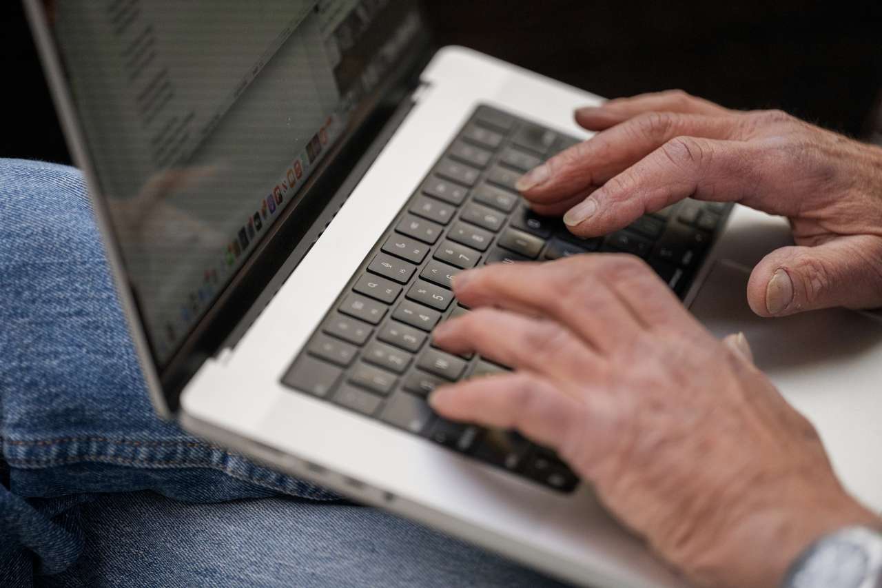 Izak Ben-Meir types on a laptop