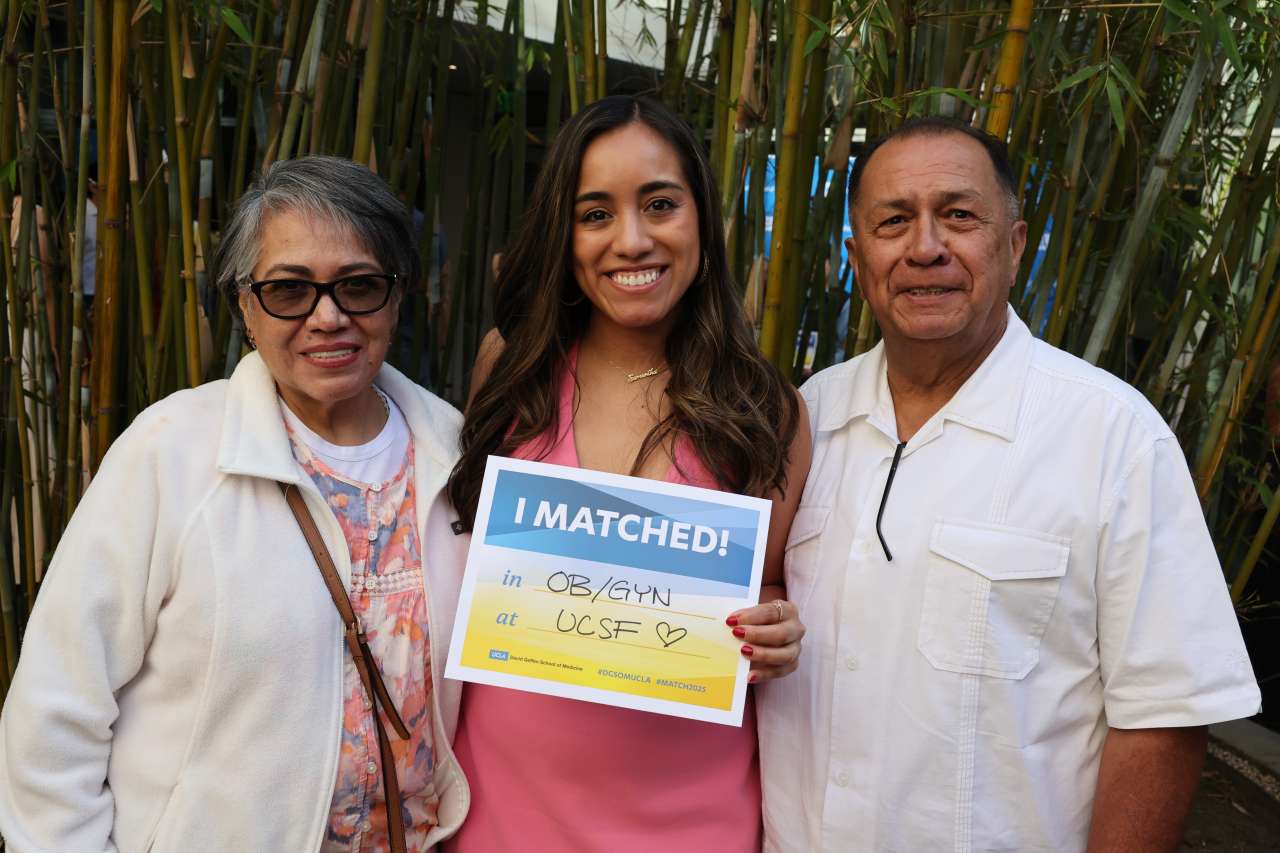 Samantha Garcia and her parents on Match Day in an outdoor setting