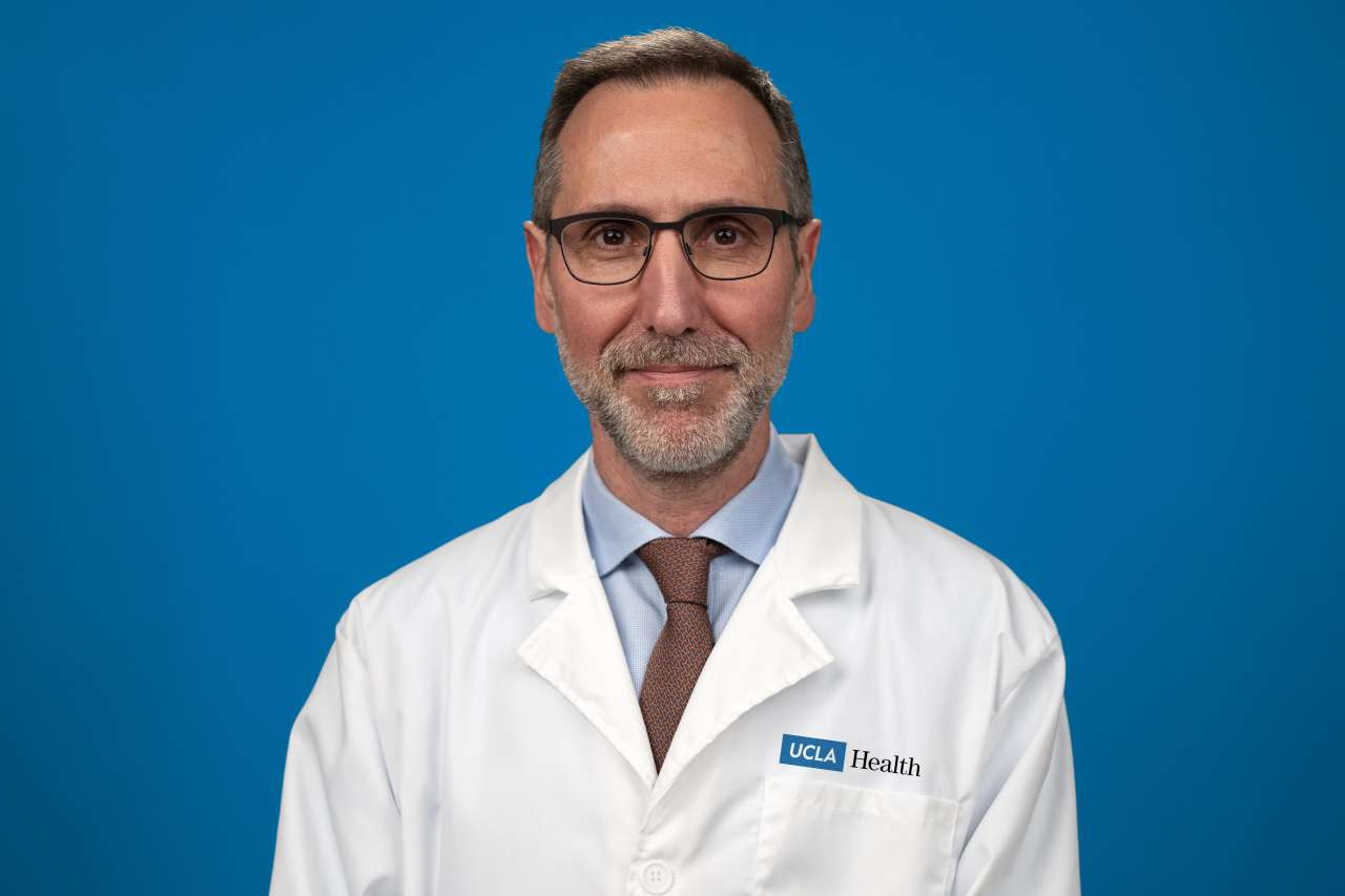 Dr. Antoni Ribas standing in front of a blue background