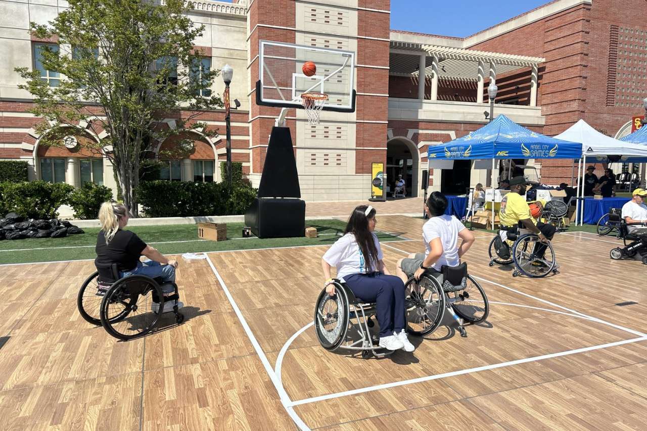 Rx to Play Program. Para-athletic or disabled people playing basketball on their wheelchairs.