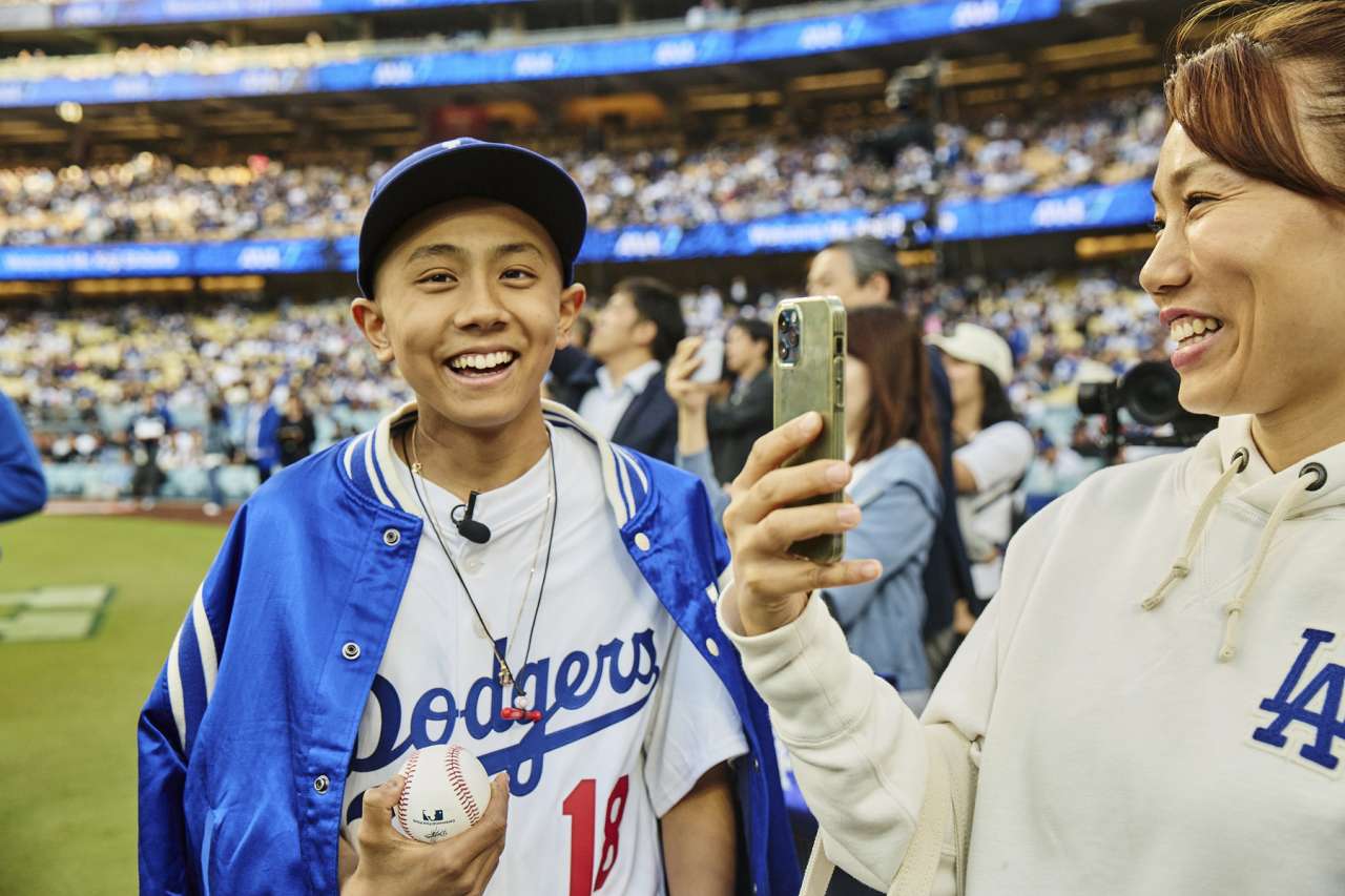 A pediatric oncology patient and his mother on the field at Dodger Stadium.