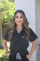 Headshot of Neda Javadi, who is wearing black scrubs.