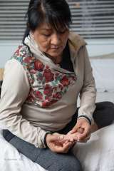 Woman checking feet for ulcers. Diabetes program.