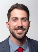 Headshot of Cameron Allred in grey suit