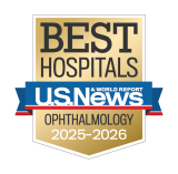 Gold badge with "Best Hospitals" at the top, a blue ribbon with "U.S. News & World Report," and "Ophthalmology 2025-2026" below.