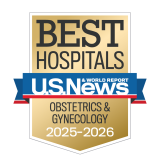 Gold badge with "Best Hospitals" at the top, a blue ribbon with "U.S. News & World Report," and "Obstetrics & Gynecology 2025-2026" below.