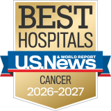 Gold badge with "Best Hospitals" at the top, a blue ribbon with "U.S. News & World Report," and "Cancer 2026-2027" below.