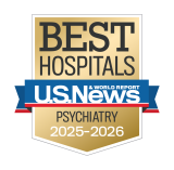 Gold badge with "Best Hospitals" at the top, a blue ribbon with "U.S. News & World Report," and "Psychiatry 2025-2026" below.