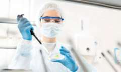 Scientist using petri dish and syringe