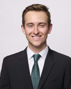 Head shot of Dr. Brendan Colgan in a suit, smiling at the camera