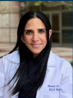 Female physician in white coat smiling in headshot