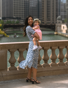 Lori Laddaran, MD and baby in Chicago, IL standing on bridge posing for photo
