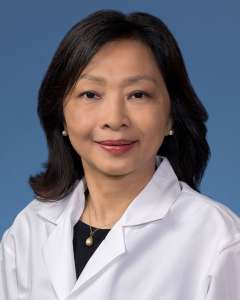Nwe Nwe Soe, MBBS, PhD, F(ACHI) in a white lab coat