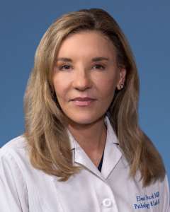 Elena Stark, MD, PhD in a white lab coat