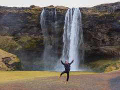 Niko Massaly, PhD, jumping in front of a waterfall