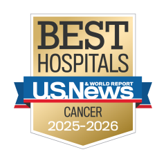 Gold badge with "Best Hospitals" at the top, a blue ribbon with "U.S. News & World Report," and "Cancer 2025-2026" below.