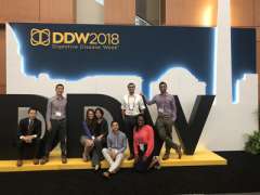 Fellows in front of DDW Sign
