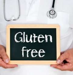 Doctor holding chalkboard with the words "Gluten Free" 