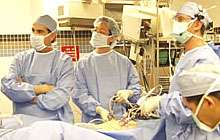 Surgeons viewing an monitoring during surgery