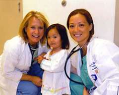 Nurses and little girl smiling