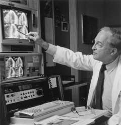 Professor Joseph K. Perloff studying X-ray images
