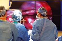 Surgeons looking at enhanced view of patients internals
