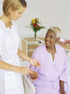 A nurse speaking with an older patient