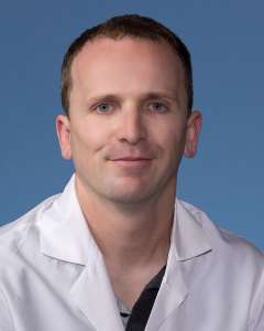 Harry Pickering, PhD in a white lab coat