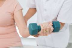 A woman exercising with a dumbell 