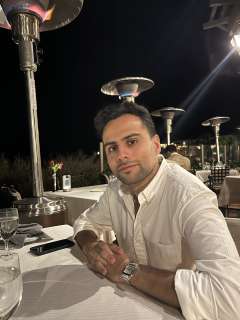 Dr. Husein at a dinner with a white shirt