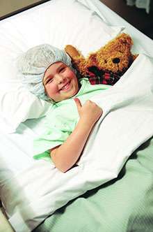 Child laying in bed preparing for surgery
