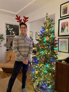 Neil Shaw, MD standing next to Christmas Tree