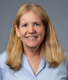 Laurie Goodyear headshot wearing a light blue lab coat.