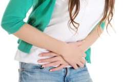 Female holding her stomach in pain