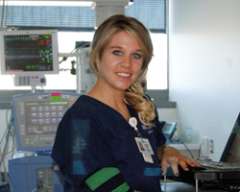 Nurse Jennifer smiling inside of hospital room