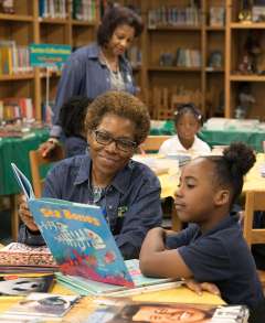 Linda Ricks reading with a young student