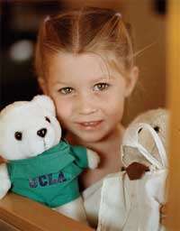 Girl holding two stuffed animals