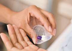 Pouring medication into patients hand