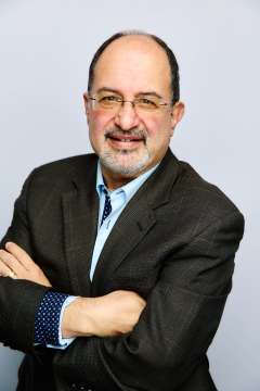 Professional photo of Dr. Arash Naeim wearing a suit and tie