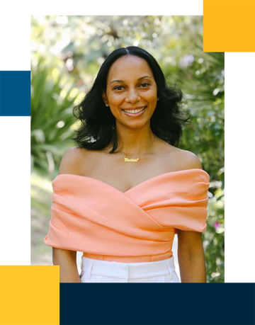 Courtnie Brown wearing a coral blouse with garden plants as the background