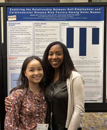Serinee Tran and mentor Dr. Kimberly Narain stand in front of Serinee’s research poster on self‑employment and cardiovascular risk in Asian women
