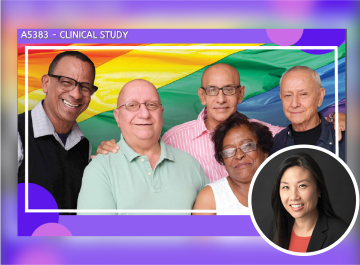 A group of smiling people standing in front of a rainbow flag