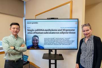 Authors stand next to image of study