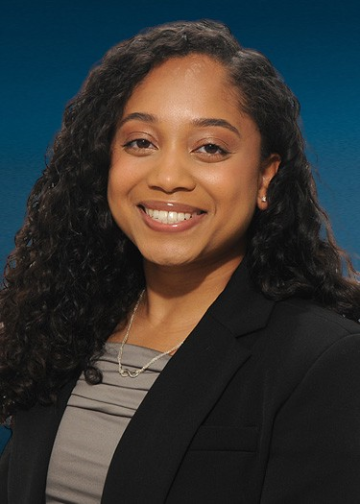 Head shot of Rehana Persaud in business attire smiling at the camera