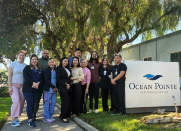 Group of people standing by Ocean Pointe sign