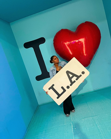 DAPM Quenesha Caballero holding an "LA" sign 
